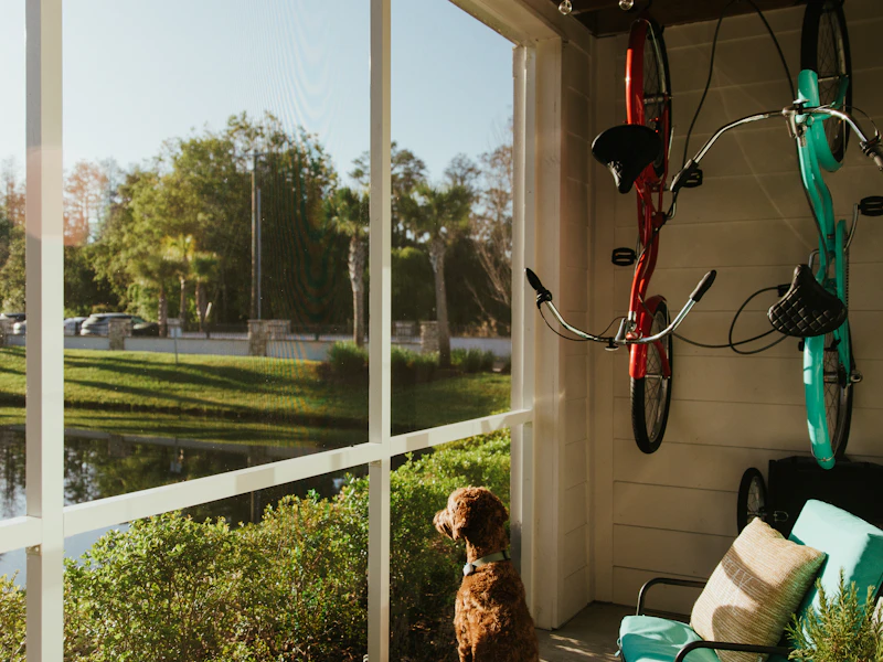Screened lanai with seating looking out onto a sunny Florida backyard